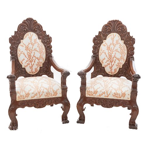 Par de sillones. Siglo XX. En talla de madera. Con respaldo cerrado y asientos en tapicería color beige y soportes tipo garra.