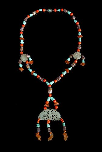 A Chinese Pale Celadon and Hardstone Necklace
Length 18 1/2 in., 47 cm. 