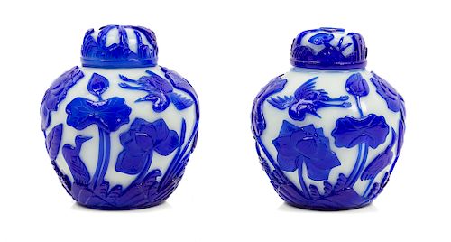 A Pair of Chinese Sapphire-Blue Overlay White Peking Glass Ginger Jars and Covers
Each: height 5 3/4 in., 15 cm. 