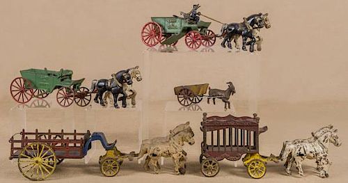 Four cast iron horse drawn wagons, to include Ov