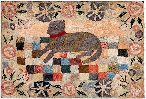 Large hooked rug of a recumbent dog