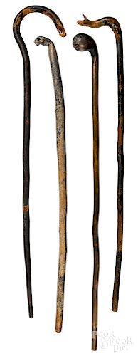 Four carved walking sticks, late 19th c.