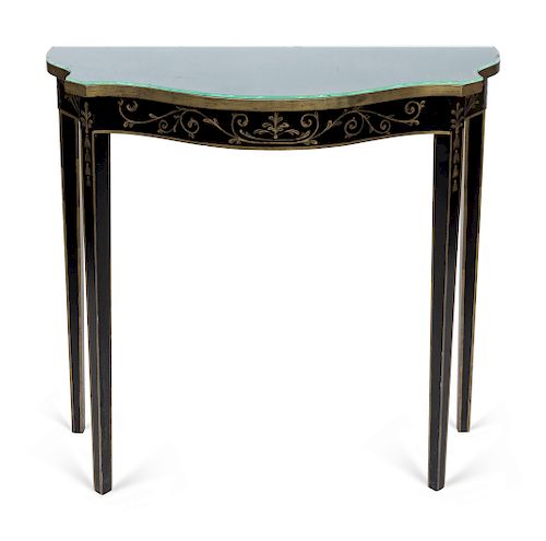 A Hollywood Regency Style Black and Gilt Painted Console Table
Height 31 1/2 X width 33 1/4 X depth 14 inches.