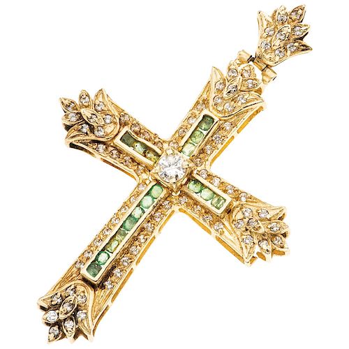 A diamond, emerald and simulant 14K yellow gold cross.