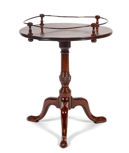 A Chippendale Style Mahogany Tilt-Top Tea Table
Height 30 x diameter 23 3/4 inches.