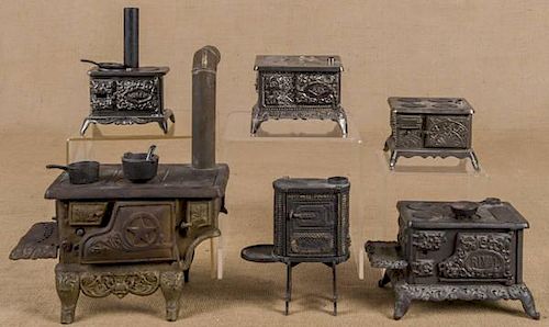 Three Kenton cast iron, nickel, and tin toy stove