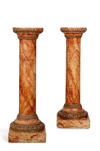 A pair of parcel gilt faux marble pedestals
