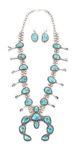 A Navajo Silver and Turquoise Squash Blossom Necklace Length of necklace 24 inches, naja 3 3/4 x 3 1/2 inches.