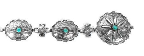 A Navajo Silver and Turquoise Concha Belt Length 32 inches buckle diameter 2 1/4 inches.