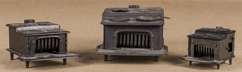 Three cast iron toy stoves, largest - 5'' h., 7 1/