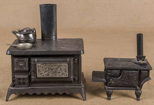 Two cast iron and nickel toy stoves, to include a
