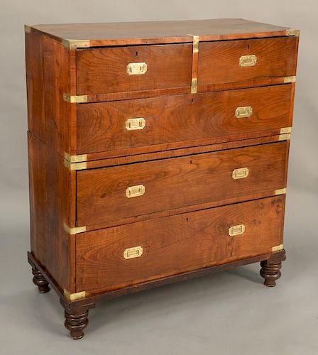 Campaign chest in two parts, with brass bindings and turned legs, 19th century. height 47 3/4 inches, width 42 inches, depth 20 inches.