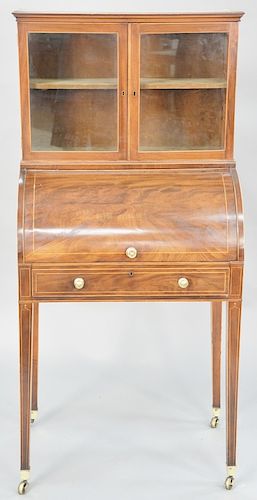 Regency mahogany secretaire desk in two parts, with the upper section having double glazed doors over a base with cylinder roll set on tall tapered le