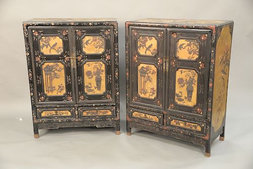 Pair of Chinese coromandel lacquered cabinets, two doors over two drawers having gilt and painted panels with birds perch on trees. height 48 inches, 