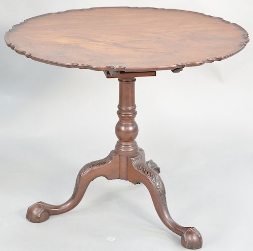 Chippendale mahogany table, having large pie crust top on turned shaft set on tripod base with scroll carved knees ending in ball and claw feet. heigh