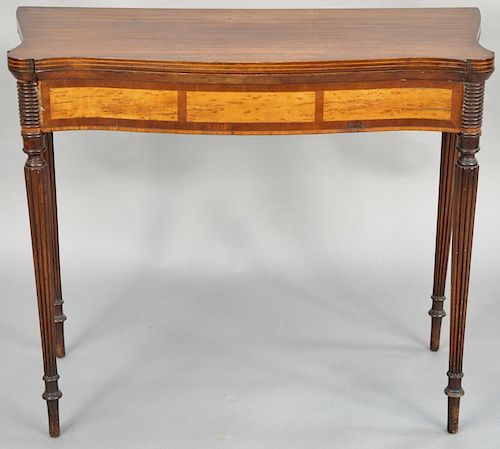 Sheraton mahogany games table, having shaped top with conforming frieze having birdseye maple panels all set on fluted legs, circa 1830. height 30 1/2