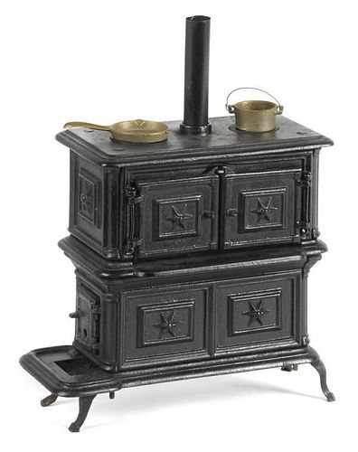 Cast iron toy stove, 10'' h., 10'' w., together wit