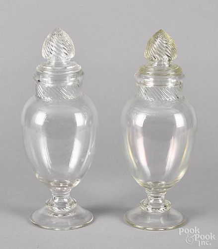 Pair of colorless glass urn-form covered apothecary jars, 19th c., 15'' h.