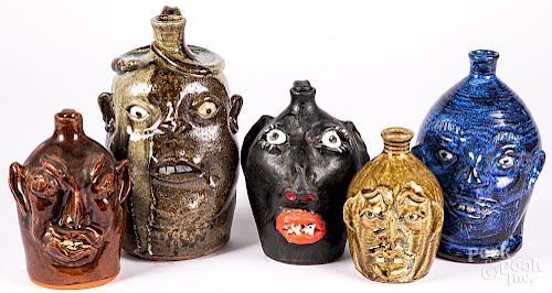 Five stoneware face or grotesque jugs