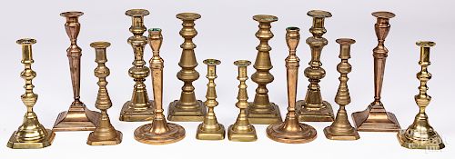 Seven pairs of Victorian brass candlesticks