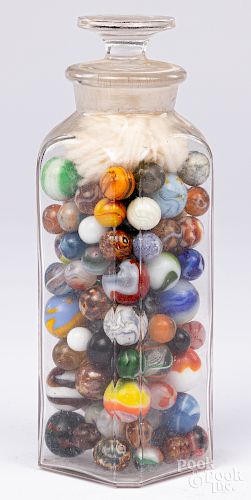 Collection of antique marbles in a glass jar