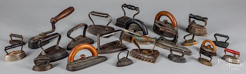 Collection of twenty-two cast iron sad irons