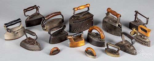 Collection of fourteen cast iron sad irons