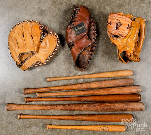 Collection of baseball bats and gloves