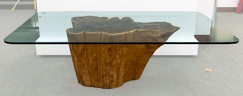 A CONTEMPORARY GLASS-TOP TABLE WITH WOODEN BASE