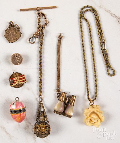 Group of gold and gold tone antique charms.