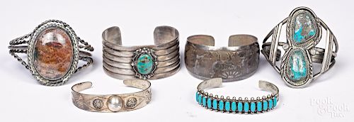 Six Native American silver bracelets.