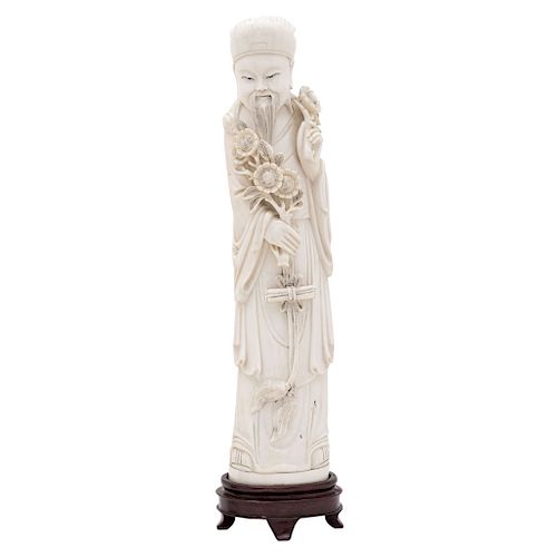 OLD MAN WITH FLOWERS. CHINA, EARLY 20TH CENTURY. Carved ivory with black ink details. 13 in tall.