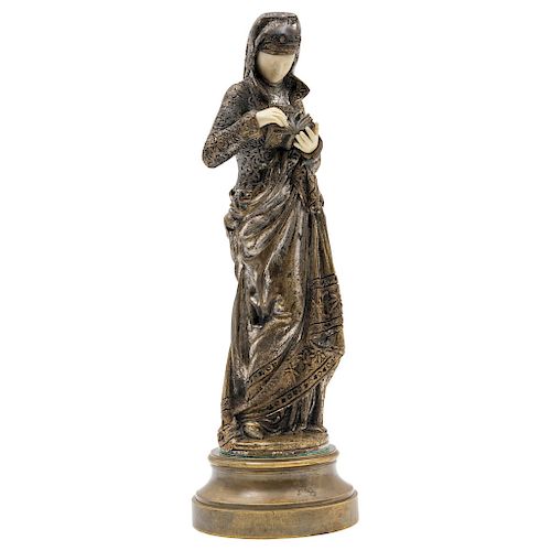 AFTER ALBERT ERNEST CARRIER-BELLEUSE (FRANCE, 1824-1887). LADY WITH BOOK (LA LISEUSE). Gilded and silver sculpture with ivory details. With signature 