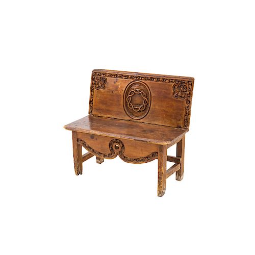 BENCH. MEXICO, LATE 19TH CENTURY. Carved wood, decored with scrolls, fleur-de-lys and crown of thorns in the center.