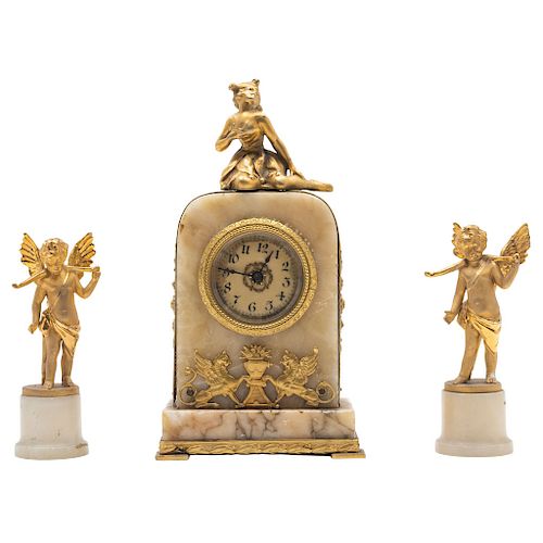 MINIATURE CLOCK AND TWO CANDLESTICKS. FRANCE, 19TH CENTURY. gilded bronze with details in champlevé enamel. Decoration with vegetal, floral and geomet