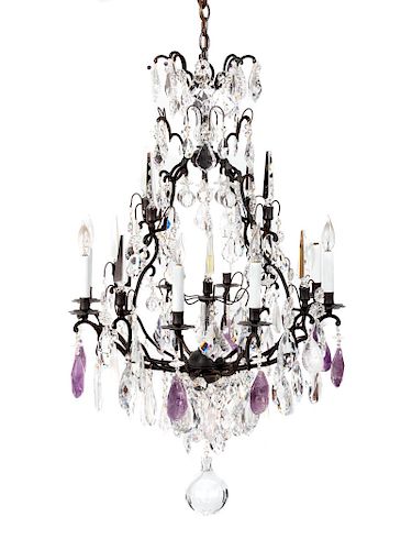 A Louis XV Style Bronze and Crystal Eight-Light Chandelier
Height 34 x diameter 27 inches.