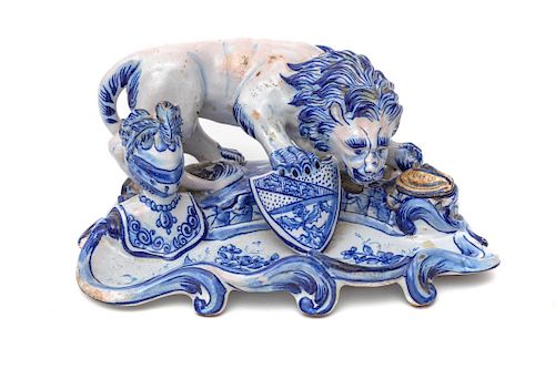An Italian Majolica Lion-Form Ink Stand
Height 4 1/2 x width 9 1/2 inches.