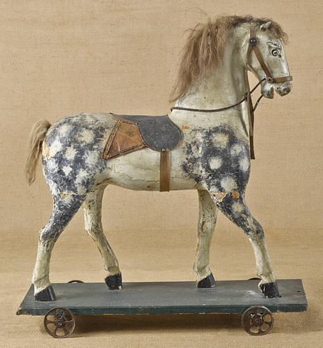 Carved and painted horse pull toy, 27'' h., 24'' l.