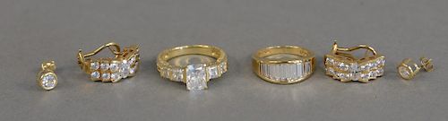 14K gold lot to include two rings and two pairs of earrings, all mounted with cubic zirconias, 18 total grams.