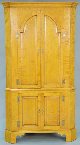 Eldred Wheeler tiger maple two part corner cupboard with two doors over twoo doors on bracket base. ht. 82 in., wd. 42 in.