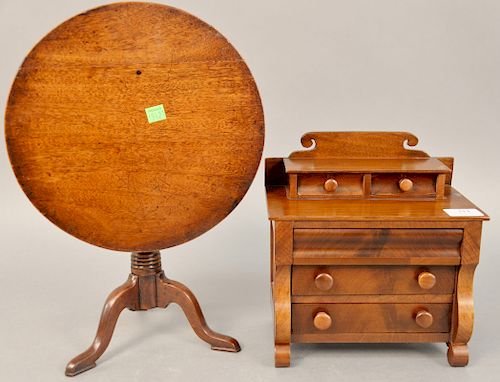 Two piece salesman sample cherry and mahogany Empire chest, ht. 10 1/4 in., wd. 9 1/2 in., and a diminutive tip table, dia. 11 1/2 in., 19th century.