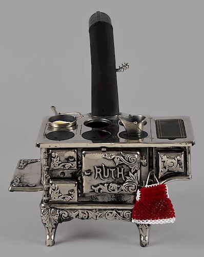 Cast iron, nickel, and tin Ruth toy stove, 8 3/