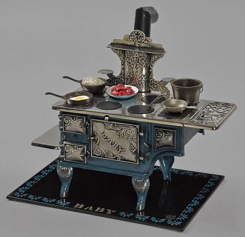 Cast iron, nickel, and tin Baby toy stove, 14 3