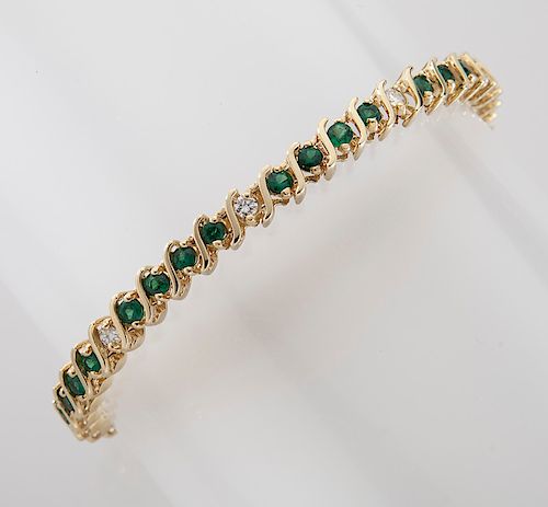 14K gold, diamond and emerald line bracelet.