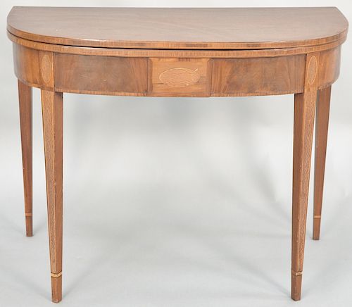 Federal mahogany game table set on square tapered legs, circa 1800. height 28 1/4 inches, width 36 inches, depth 17 1/2 inches.