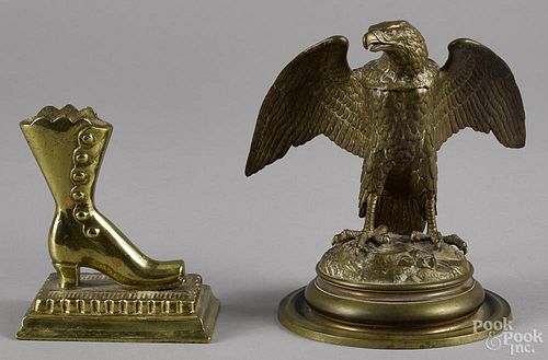 Bronze spread winged eagle inkwell, early 20th c., 7'' h., together with a brass boot match holder