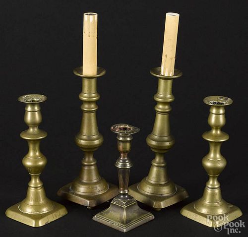Two pairs of antique brass candlesticks, together with a single stick, tallest - 9 1/4''.