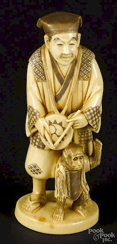 Japanese Meiji period carved ivory figure of a man with a monkey, 6'' h.