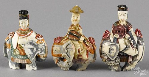 Three Chinese carved and painted ivory snuff bottles, ca. 1900, each of a figure riding an elephant
