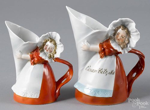 Two Royal Bayreuth porcelain milkmaid cream pitchers, one inscribed Ocean City MD
